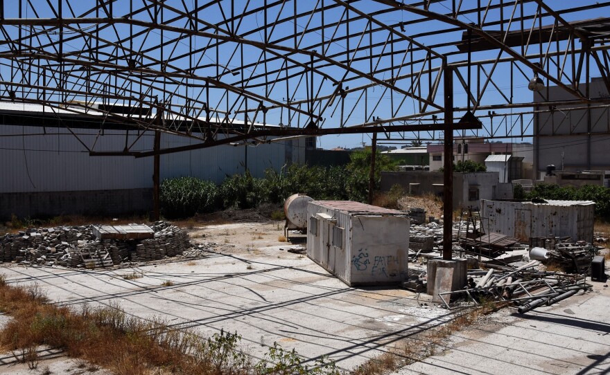 Faysal Shawa's warehouse was damaged in the 2014 conflict. Shawa and employees maintain no connection to Hamas.