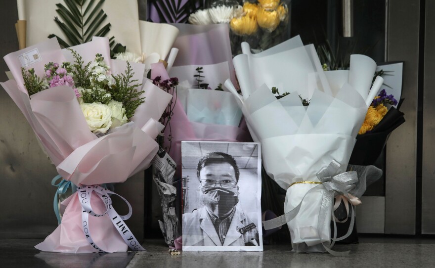 Flowers and a portrait of Dr. Li Wenliang is left at his hospital in Wuhan, China. Li, regarded a whistleblower in the coronavirus outbreak, died of the infectious disease on Friday.
