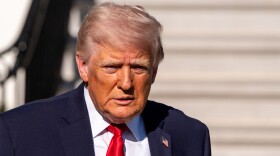 President Trump speaks with reporters before departing on Marine One from the South Lawn of the White House on April 11 in Washington.