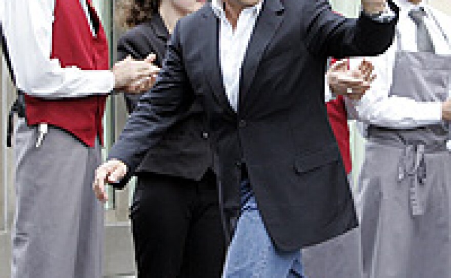 French President-elect Nicolas Sarkozy leaves Fouquet's restaurant on Paris' Champs Elysees, May 7.