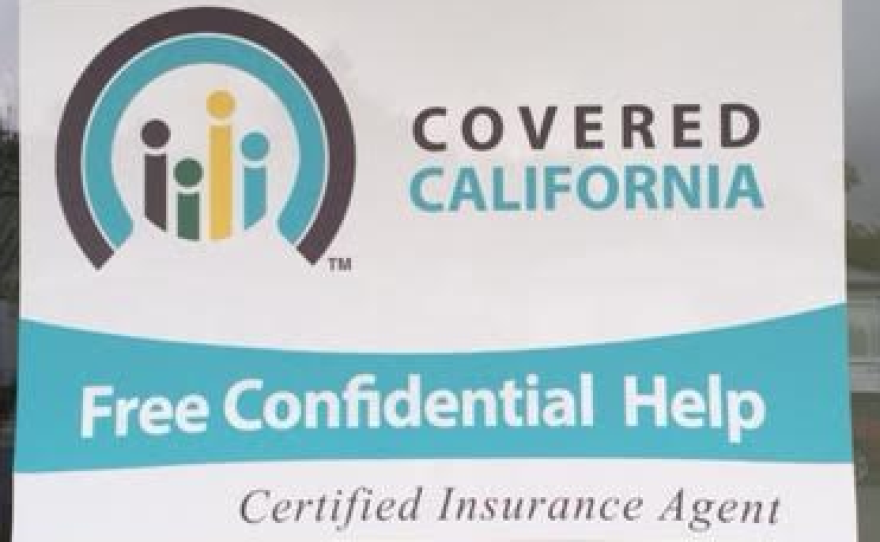 A Covered California sign is shown on the door of a La Mesa insurance agent's business, April 9, 2016.