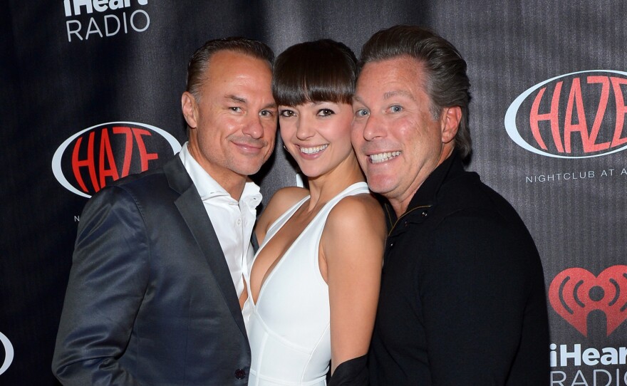 Ross Levinsohn (right), with his frequent business collaborator, James Heckman, at a 2014 iHeartRadio party at CES in Las Vegas. They are accompanied by Heckman's wife, Emilia.