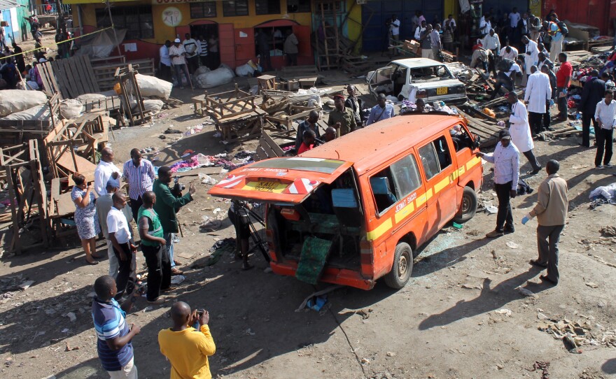 Security officers patrol the scene of an explosion aboard a minibus in the Gikomba market area of Nairobi, Kenya, on May 16. The Kenyan capital was hit by two explosions that day -- a day after Western tourists were evacuated from Mombasa.