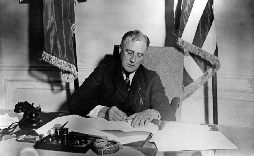 President Franklin D. Roosevelt signs the Emergency Banking Act into law on March 9, 1933. Roosevelt signed a record 15 major pieces of legislation in the first 100 days of his presidency.