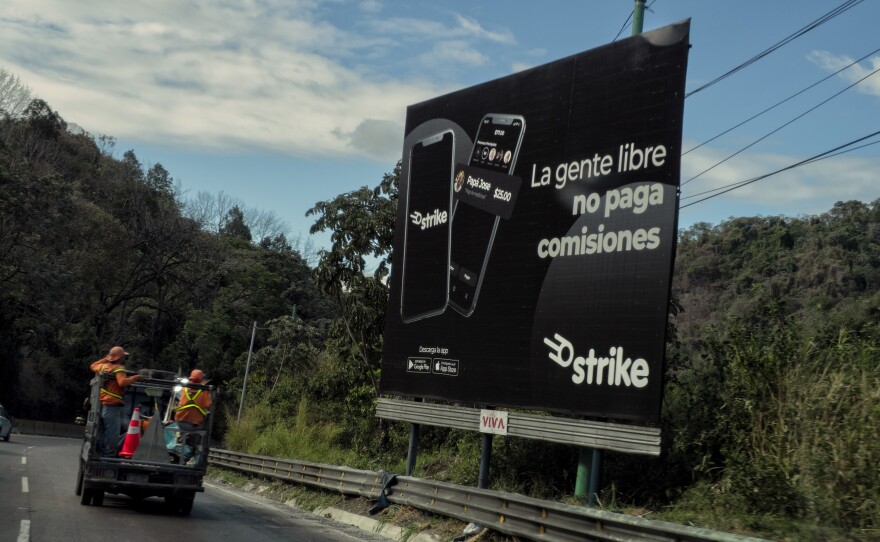 An advertisement for the digital wallet Strike, used in El Zonte, El Salvador, as a way to do bitcoin transactions. Through the app, users can buy and sell bitcoins or make and receive various kinds of payments.