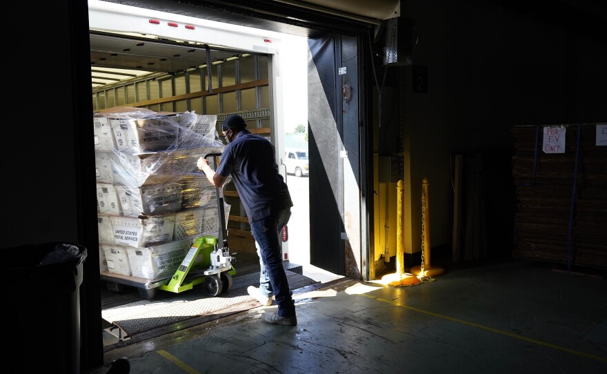 Absentee ballots are loaded onto a truck for mailing earlier this month at the Wake County, N.C., Board of Elections.