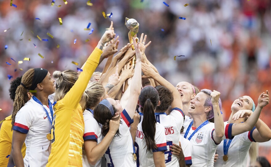 U.S. Women's National Team players celebrate with the FIFA Women's World Cup Trophy following team's victory Sunday.