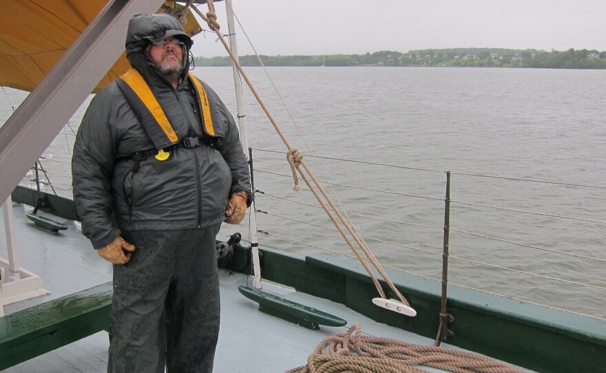 Bosen Len Ruth bundles against the weather. Canal schooners used wind power on open lakes, and lowered their masts and raised their centerboards to be towed through canals.