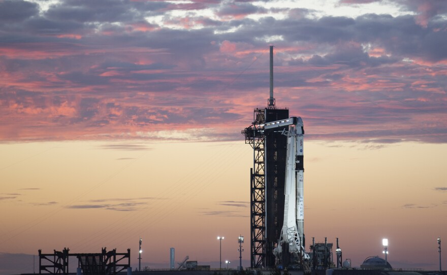 In this image released by NASA, a SpaceX Falcon 9 rocket with the company's Crew Dragon spacecraft onboard stands upright at sunset on the launch pad as preparations continue for the Crew-3 mission. The rocket, bound for the International Space Station, is scheduled to launch early Sunday, Oct. 31.