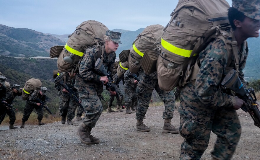 Female Marine recruits summiting the Reaper, the highest point in Camp Pendleton, and the last obstacle in their three-day, 54-hour Crucible, their last test before becoming Marines, April 22, 2021.