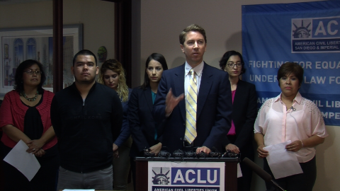 Sean Riordan (center), senior staff attorney for the ACLU of San Diego and Imperial Counties, talks to reporters about the settlement of an immigration lawsuit, August 27, 2014.