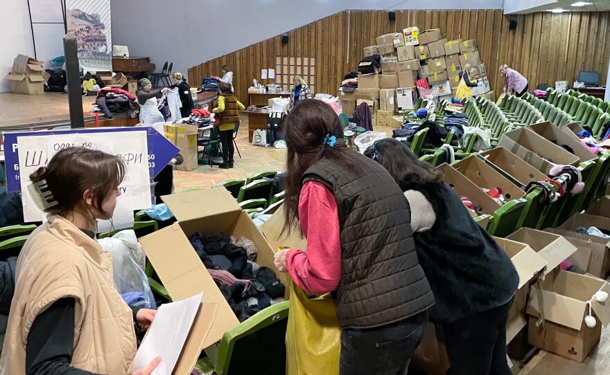 Women sort donated socks in a theater now being used as an aid distribution hub in downtown Lviv, Ukraine.