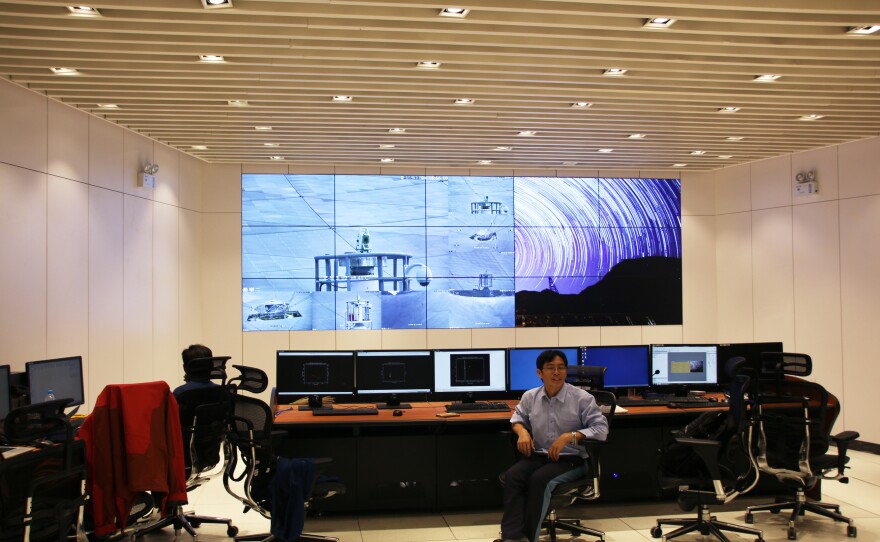 Lead scientist Zhu Ming sits in the telescope's control center. Clusters of supercomputers process millions of gigabytes of data each day, representing the radio traffic of the universe that is picked up by the telescope.