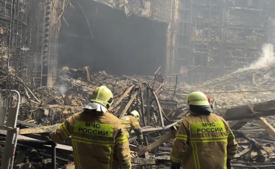 Firefighters work in the burned concert hall after an attack on the western edge of Moscow, Russia. ISIS-K has claimed responsibility for the attack.