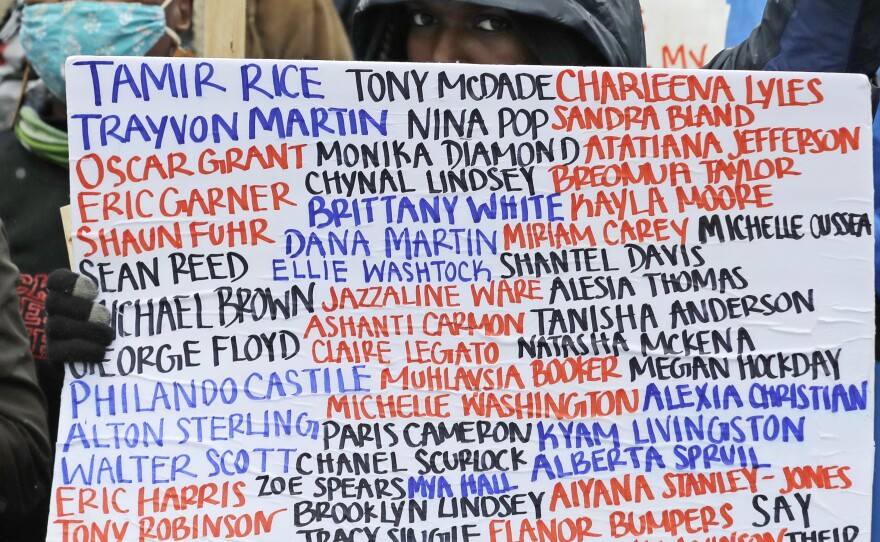 A sign at a June 2020 protest against racial injustice and police violence in Seattle bears the names of people killed by police.