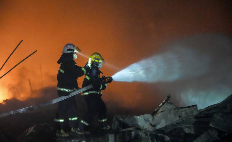 In this photo released by Xinhua News Agency, firefighters work to out the fire after an explosion at a fireworks plant in Guandu Town of Liuyang, central China's Hunan Province, in the early hours of May 5, 2026.