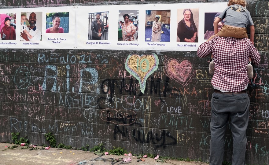 People gather at a memorial for the shooting victims outside of Tops grocery store on May 20, 2022 in Buffalo, N.Y.