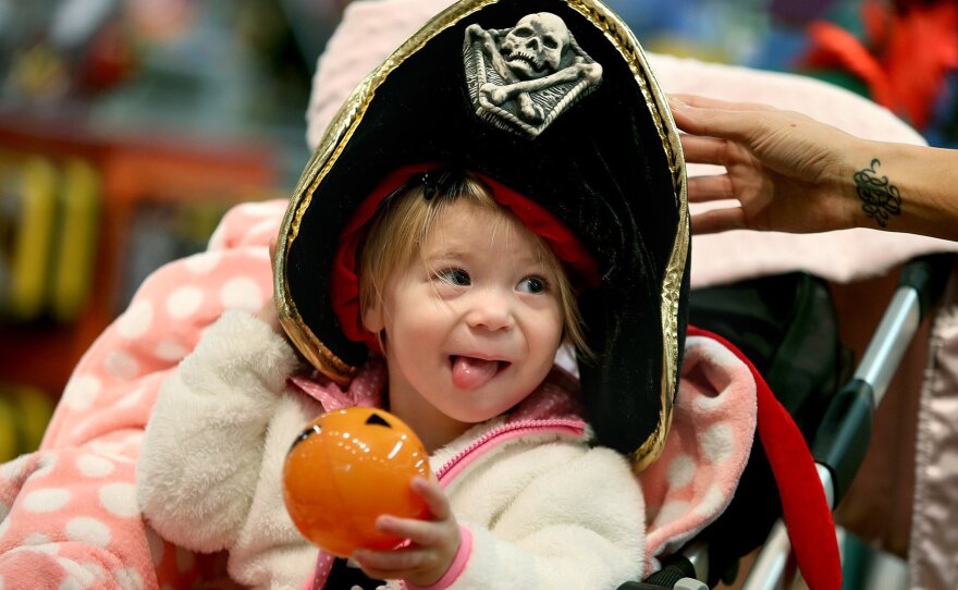 Candice Nelson fits her daughter Arya Kubesh with a Halloween hat at a store at Galleria Mall in Edina, Minn. Retailers are hoping Halloween will give them a good bounce into the peak spending time of the year.