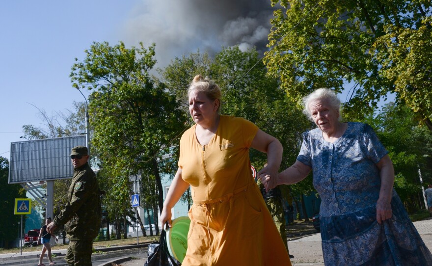Women rush across the street after shelling in the town of Donetsk, Ukraine on Wednesday.