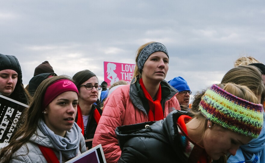 (Left) Groups of young people travelled from around the country to listen to speakers ranging from Vice President Mike Pence to Iowa Sen. Joni Ernst ahead of the march. (Right) Towson University student Edena Zeweie, 18, came with a friend. Her friend said that they were there to be "the voice for those who have no voice" and protest for Planned Parenthood to be defunded.