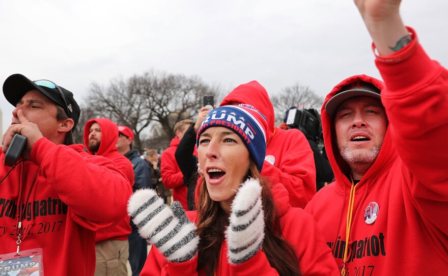 Supporters react on the National Mall to the inauguration of Donald Trump on January 20, 2017 in Washington, DC.