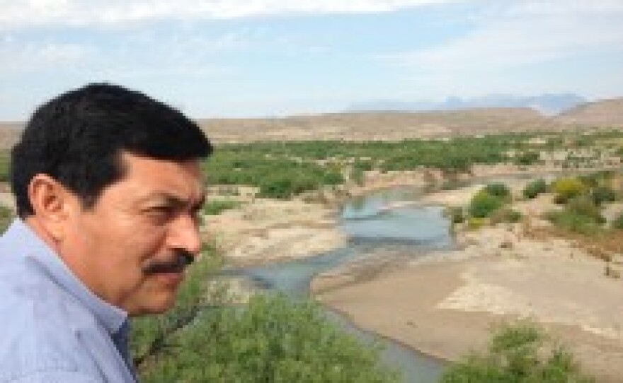 Bernado Rogel looks out over the Rio Grande river as residents prepare for a fiesta celebrating a year of the crossing being open.