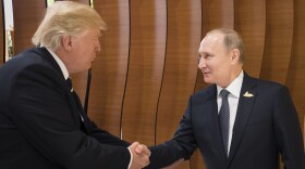 In this photo provided by the German government, U.S. President Donald Trump, left, shakes hand with Russian President Vladimir Putin before the first working session of the G-20 summit in Hamburg, northern Germany. 