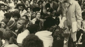 Kunstler (right) at a New York City rally to protest the deaths of 40 inmates at Attica State Prison, 1971. Holding the speaker horn is Charles Kenyatta, former bodyguard of Malcolm X.