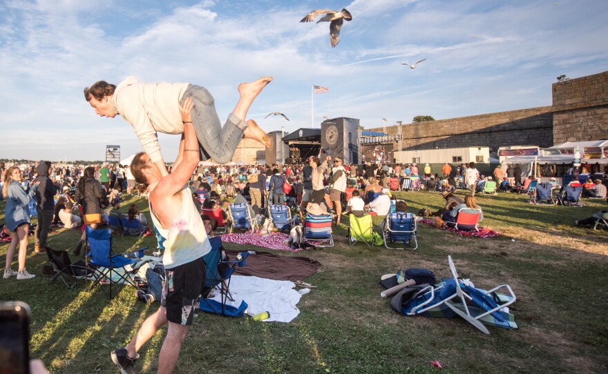Two audience members dance during Wilco's set at the 2017 Newport Folk Festival.