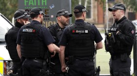 Armed police keep guard near Victoria Station in Manchester, England, Wednesday, May 24, 2017.