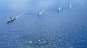 Ships and aircraft assigned to the Nimitz Carrier Strike Group (CSG) 11 operate in formation in the South China Sea in 2010. 