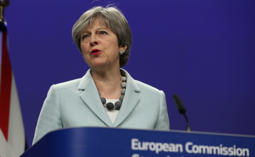 British Prime Minister Theresa May speaks during a joint news conference with European Commission Chief Jean-Claude Juncker in Brussels, Belgium on Friday.