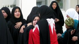 Women in Manama, Bahrain, mourn over the dead and wounded from Thursday morning's police raid of a protesters' camp in the capital's central square.