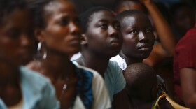 Young women listen to a talk on domestic violence and HIV prevention near Lome, Togo, in April. Abused women in sub-Saharan Africa and India are at higher risk for HIV than women who haven't experienced violence.