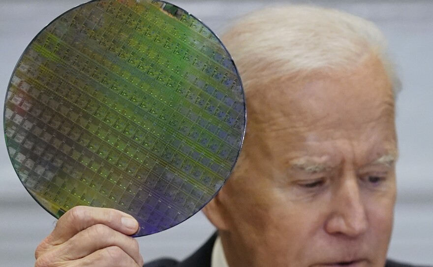 President Biden holds up a silicon wafer in this 2021 file photo.