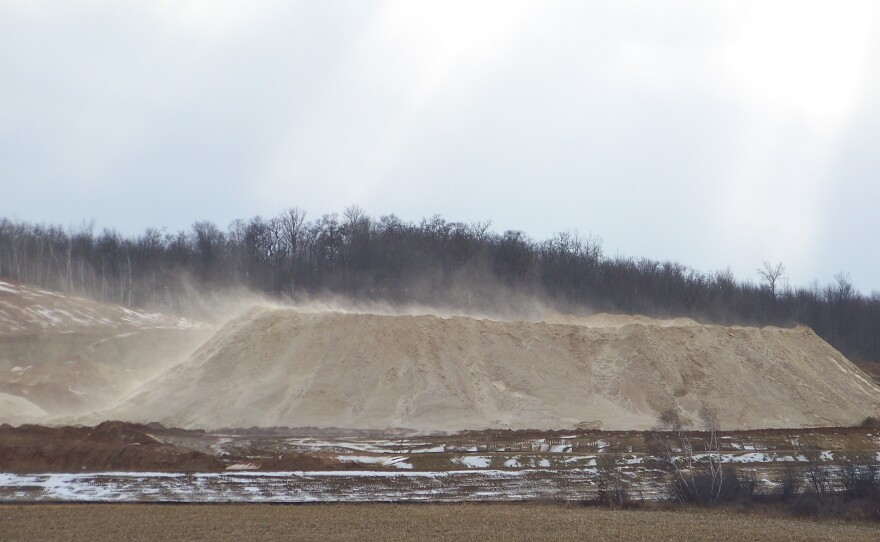 Dust blows off a pile of fracking sand at a mine near Chippewa Falls, Wis., on Dec. 15, 2011. Some of the air samples the National Institute for Occupational Safety and Health experts collected at fracking sites had such high levels of silica that the respirators typically worn by workers wouldn't offer enough protection, according to NIOSH standards.
