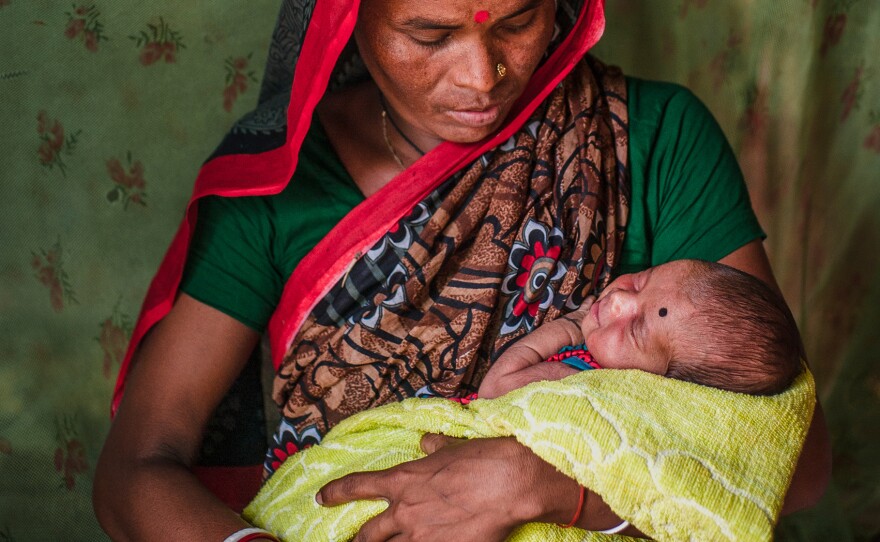 Rong Mala, 30, with her 6-day-old child Rakhal, who recently had a post-natal check up at the government clinic built in partnership with Save the Children in eastern Bangladesh.
