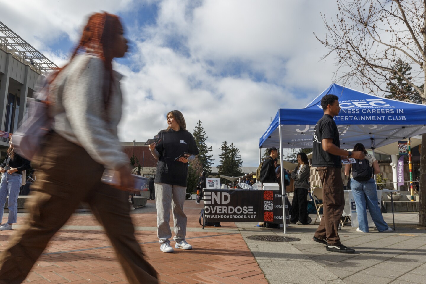 UC Berkeley End Overdose Co-Presidents Shannon McCabe (left) and Tyler Mahomes (right) pass out free fentanyl test strips at Sproul Plaza on campus in Berkeley on Jan. 23, 2024.