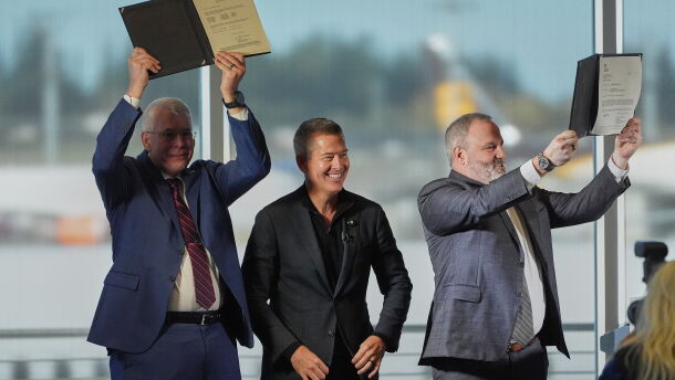 U.S. Transportation Secretary Sean Duffy, center, reacts while presenting the certification of Boeing's 737 Max 10 aircraft to Jim Williams, Boeing 737 Development Program chief engineer, at left, and Chris Payne, Boeing Commercial Airplanes vice president and program manager, 737 Development Programs, right, Tuesday, Oct. 20, 2026, at Boeing's factory in Everett, Wash.