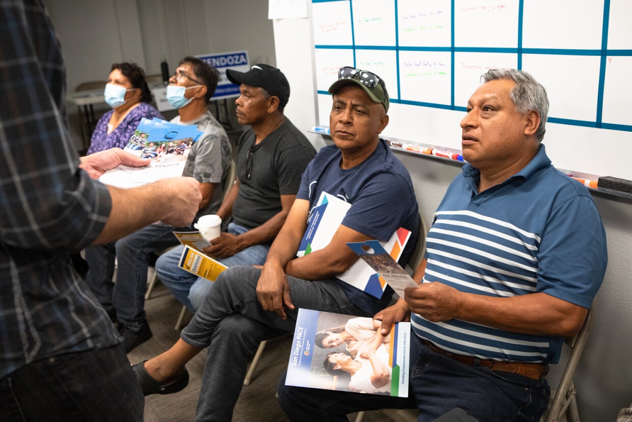 North county residents are handed election materials by Paul Mendoza, a candidate for the Vallecitos Water District, at the Universidad Popular election education fair in San Marcos, Oct. 20, 2022.