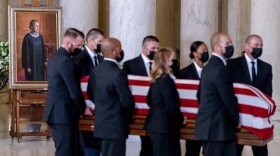 The flag-draped casket of Justice Ruth Bader Ginsburg, carried by Supreme Court police officers, arrives in the Great Hall at the Supreme Court in Washington, Wednesday, Sept. 23, 2020. 