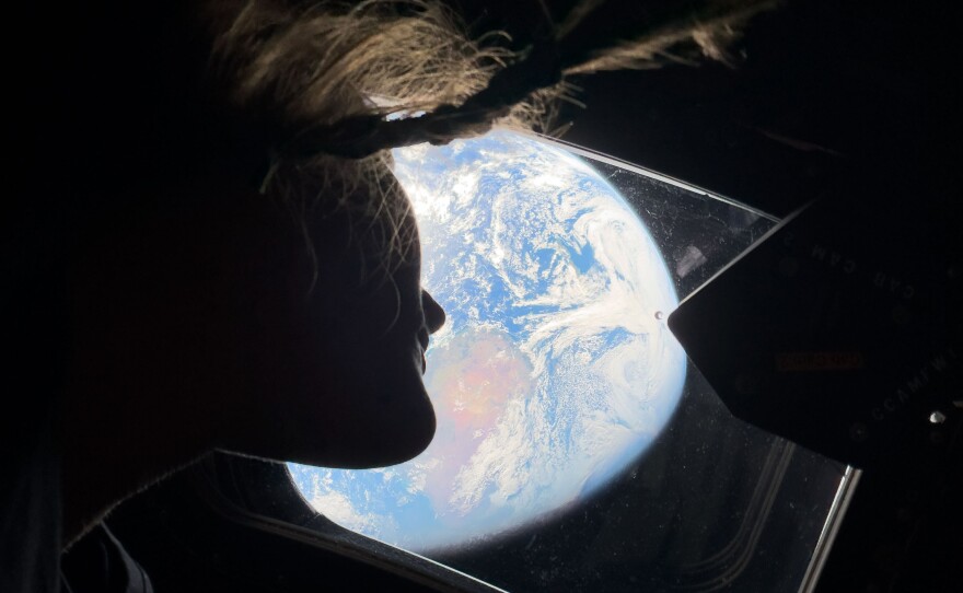 April 2: Mission specialist Christina Koch peers out one of the Orion spacecraft's main cabin windows, looking back at Earth, as the crew travels toward the moon.