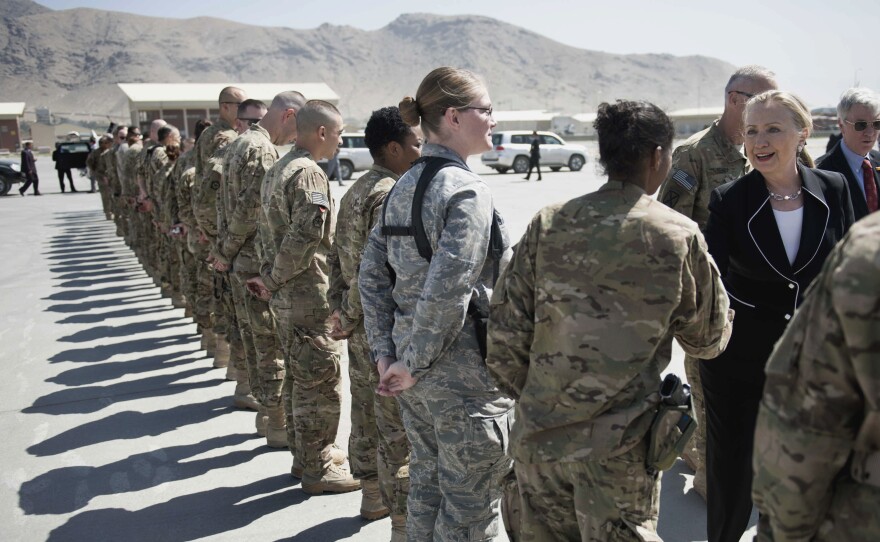 Hillary Clinton, then secretary of state, greets troops in Kabul, Afghanistan, in 2012. She logged nearly a million miles visiting 112 countries in that position.