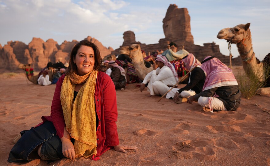 Bettany Hughes with Bedouin and their camels in the Hisma plateau of the Badja desert, Saudi Arabia.