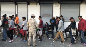 Migrants line up to eat at El Barretal, Dec. 4, 2018. 
