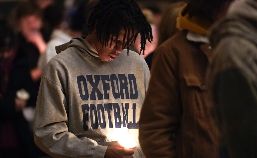 Joshua McDade, a former student at Oxford High School, attends a vigil at LakePoint Community Church in Oxford, Mich., on Tuesday.