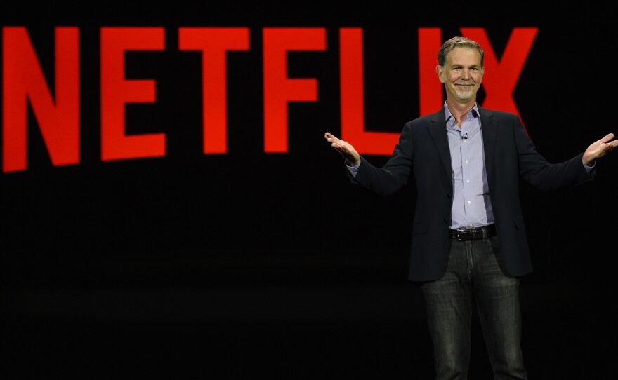 Netflix CEO Reed Hastings delivers a keynote address at CES 2016 in Las Vegas. He has admitted facing Amazon in video is a challenge.
