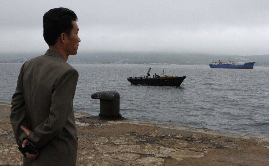 Kim Chol Ho, deputy manager of the Rajin port, in North Korea's Rason Special Economic Zone, looks out at small fishing boats. Despite stepped-up international sanctions, North Korea is still trading extensively with China.