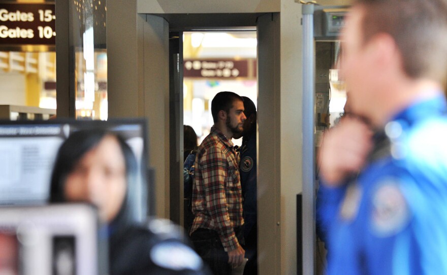 A passenger goes through a full-body scanner at Reagan National Airport in Washington, D.C., on Nov. 24, 2010.