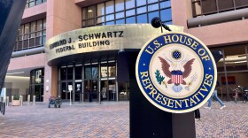 A podium for with a U.S. House of Representatives emblem stands in front of the Edward J. Schwartz Federal Building in downtown San Diego, Oct. 20, 2025.